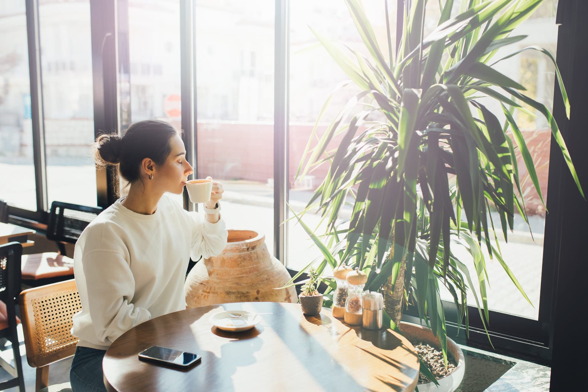Woman in a cafe enjoying her coffee.