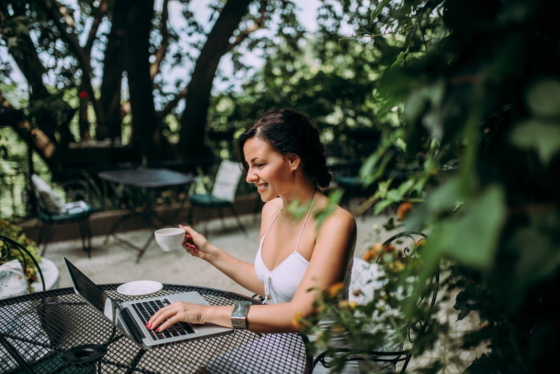 Person relaxing in a garden cafe.